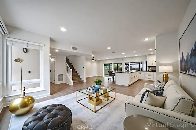 8190 Crowley Cir, Buena Park, CA 90621 - living room featuring light wood-style floors, stairway, and recessed lighting