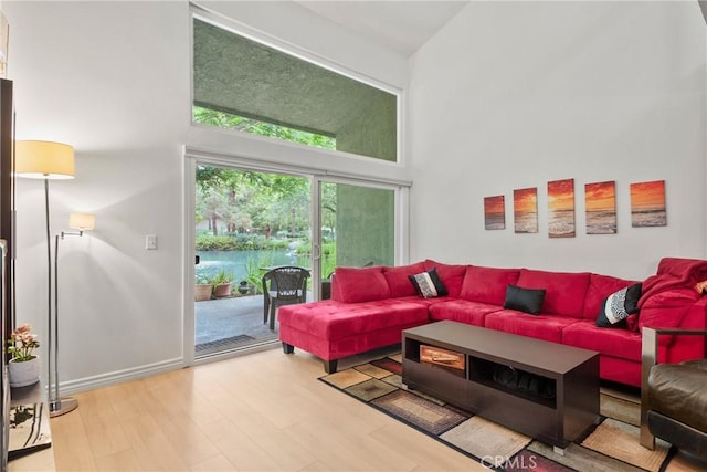 4900 E Chapman Ave Unit 102, Orange, CA 92869 - living room featuring a towering ceiling and wood finished floors