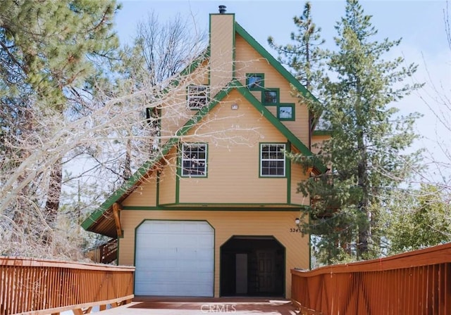 32455 Scandia Dr, Running Springs, CA 92382 - view of side of property with an attached garage, a chimney, and driveway