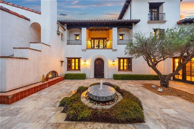 20 Cactus, Irvine, CA 92603 - mediterranean / spanish-style house featuring a balcony, a chimney, and stucco siding