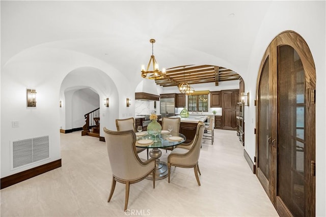 20 Cactus, Irvine, CA 92603 - dining space featuring arched walkways, a chandelier, stairs, and baseboards