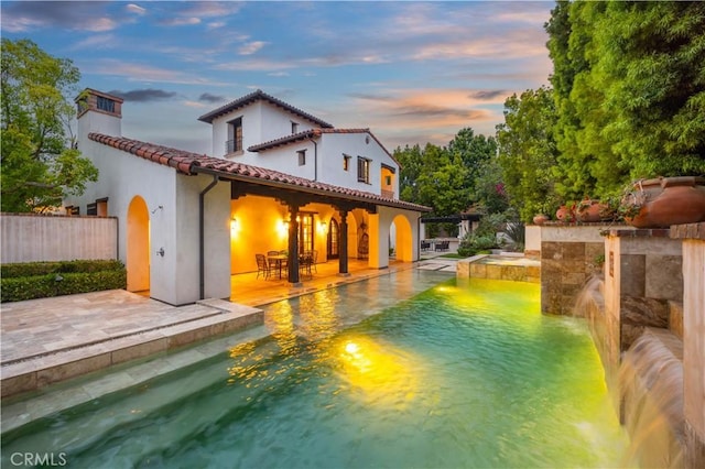 20 Cactus, Irvine, CA 92603 - back of house with a pool with connected hot tub, a patio, a tiled roof, and stucco siding