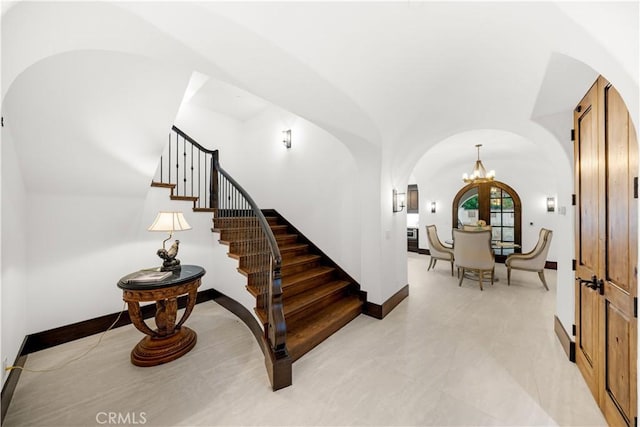 20 Cactus, Irvine, CA 92603 - entrance foyer featuring arched walkways, a chandelier, stairs, baseboards, and vaulted ceiling