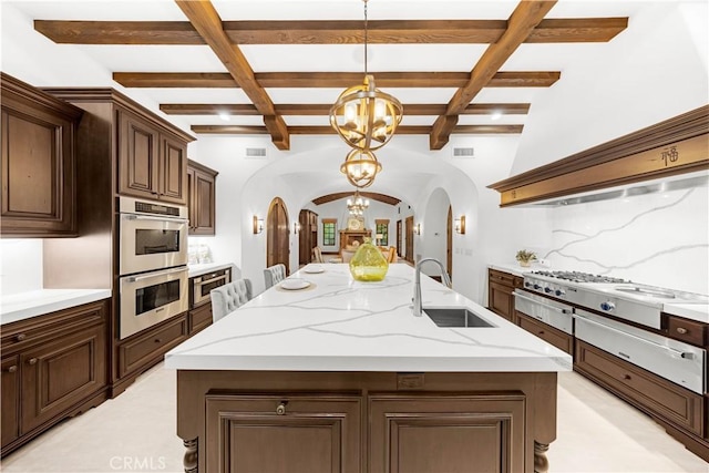 20 Cactus, Irvine, CA 92603 - kitchen featuring arched walkways, a chandelier, a sink, stainless steel appliances, and coffered ceiling