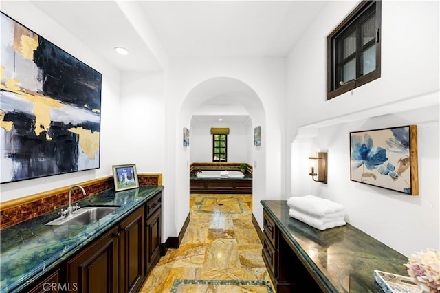 20 Cactus, Irvine, CA 92603 - hall featuring a sink, recessed lighting, arched walkways, and light marble finish flooring