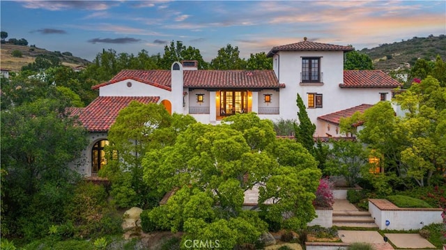 20 Cactus, Irvine, CA 92603 - mediterranean / spanish-style home with french doors, a tile roof, a chimney, and stucco siding