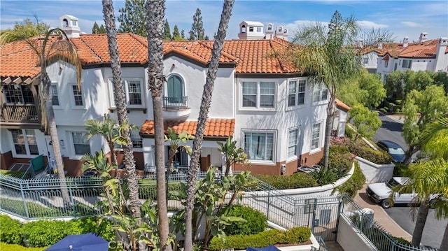 2911 Ballesteros Ln, Tustin, CA 92782 - back of house with stucco siding, a tiled roof, and a residential view
