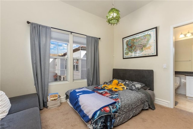 2911 Ballesteros Ln, Tustin, CA 92782 - carpeted bedroom with ensuite bathroom and baseboards