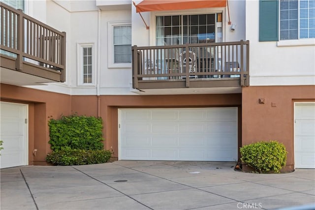 2911 Ballesteros Ln, Tustin, CA 92782 - exterior space with stucco siding, a garage, driveway, and a balcony