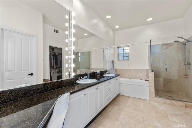 2911 Ballesteros Ln, Tustin, CA 92782 - bathroom with a shower stall, a garden tub, double vanity, a spacious closet, and recessed lighting
