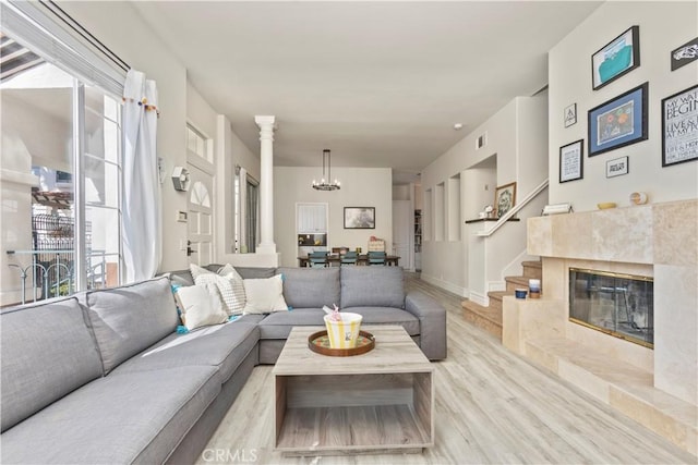 2911 Ballesteros Ln, Tustin, CA 92782 - living room featuring a chandelier, wood finished floors, and a fireplace