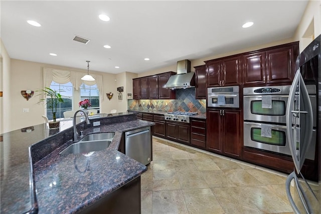 2514 Bulrush Cir, Corona, CA 92882 - kitchen featuring wall chimney range hood, a sink, stainless steel appliances, tasteful backsplash, and recessed lighting