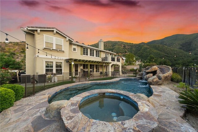2514 Bulrush Cir, Corona, CA 92882 - view of swimming pool featuring a fenced backyard, a pool with connected hot tub, a mountain view, a patio, and central AC