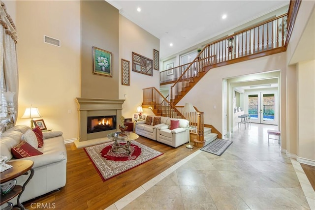 2514 Bulrush Cir, Corona, CA 92882 - living area featuring stairway, a glass covered fireplace, a high ceiling, baseboards, and recessed lighting