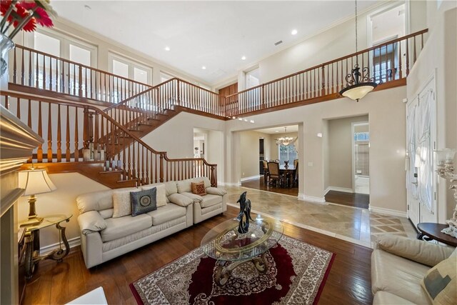2514 Bulrush Cir, Corona, CA 92882 - living area with stairway, a chandelier, baseboards, wood finished floors, and a high ceiling