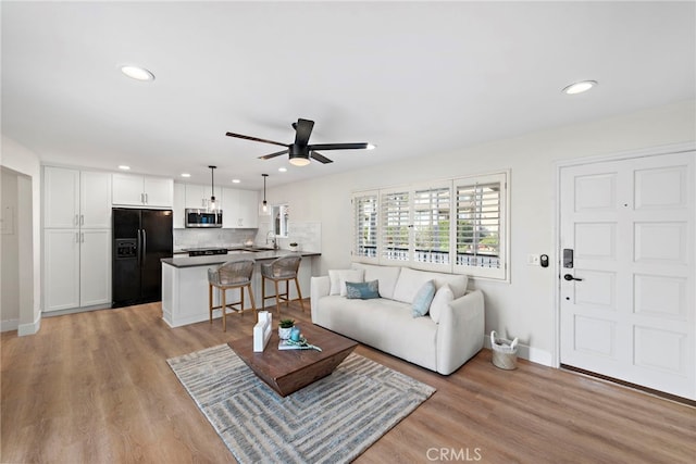2175 S Coast Hwy Unit 16, Laguna Beach, CA 92651 - living room with a ceiling fan, baseboards, recessed lighting, and light wood-style floors