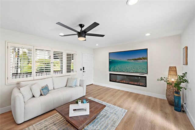 2175 S Coast Hwy Unit 16, Laguna Beach, CA 92651 - living area with baseboards, wood finished floors, ceiling fan, recessed lighting, and a glass covered fireplace