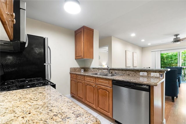 4727 W 147th St Unit 225, Lawndale, CA 90260 - kitchen featuring appliances with stainless steel finishes, a sink, a peninsula, brown cabinets, and recessed lighting