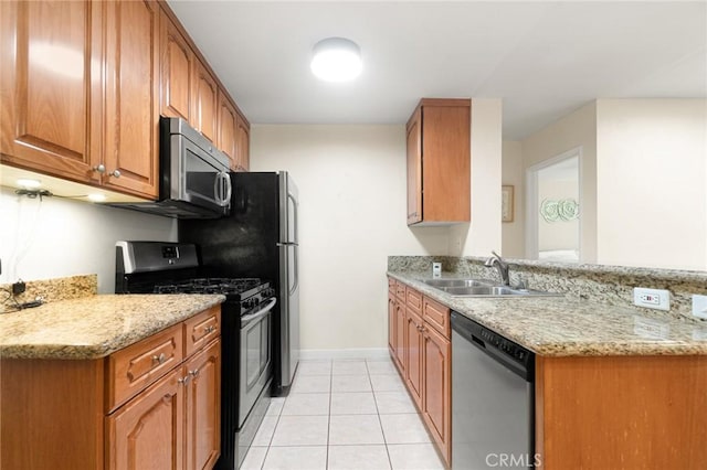 4727 W 147th St Unit 225, Lawndale, CA 90260 - kitchen featuring appliances with stainless steel finishes, a sink, light tile patterned flooring, brown cabinetry, and light stone counters