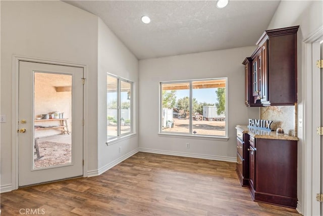 9098 Rattlesnake Rd, Phelan, CA 92371 - dining space featuring wood finished floors, vaulted ceiling, recessed lighting, baseboards, and a textured ceiling