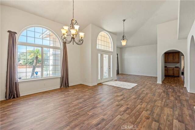 9098 Rattlesnake Rd, Phelan, CA 92371 - entrance foyer with arched walkways, dark wood-style floors, a chandelier, high vaulted ceiling, and baseboards