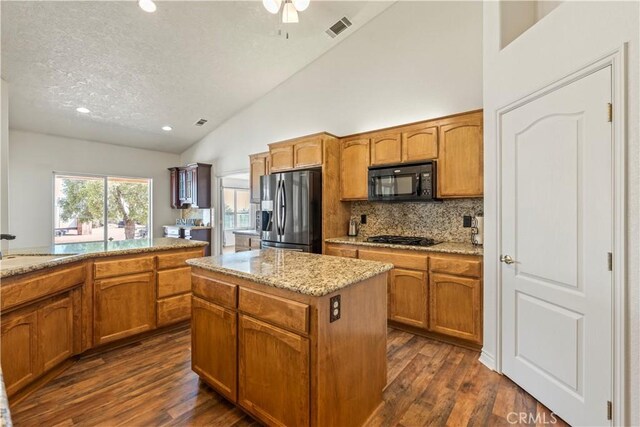 9098 Rattlesnake Rd, Phelan, CA 92371 - kitchen featuring black appliances, dark wood-type flooring, backsplash, high vaulted ceiling, and brown cabinetry