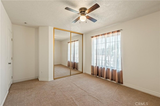 9098 Rattlesnake Rd, Phelan, CA 92371 - unfurnished bedroom with a textured ceiling, carpet floors, a closet, baseboards, and a ceiling fan