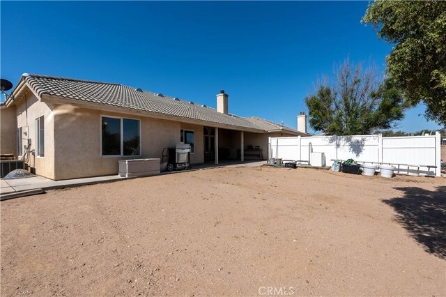 9098 Rattlesnake Rd, Phelan, CA 92371 - rear view of property featuring stucco siding, central air condition unit, a patio, and a tile roof
