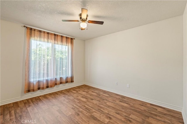 9098 Rattlesnake Rd, Phelan, CA 92371 - empty room with wood finished floors, a ceiling fan, baseboards, and a textured ceiling