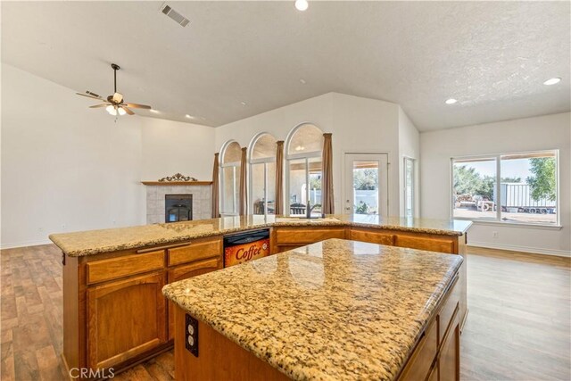 9098 Rattlesnake Rd, Phelan, CA 92371 - kitchen with a center island, dishwashing machine, open floor plan, ceiling fan, and wood finished floors