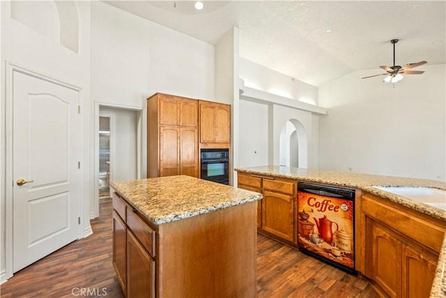 9098 Rattlesnake Rd, Phelan, CA 92371 - kitchen featuring black appliances, ceiling fan, dark wood-type flooring, a kitchen island, and high vaulted ceiling