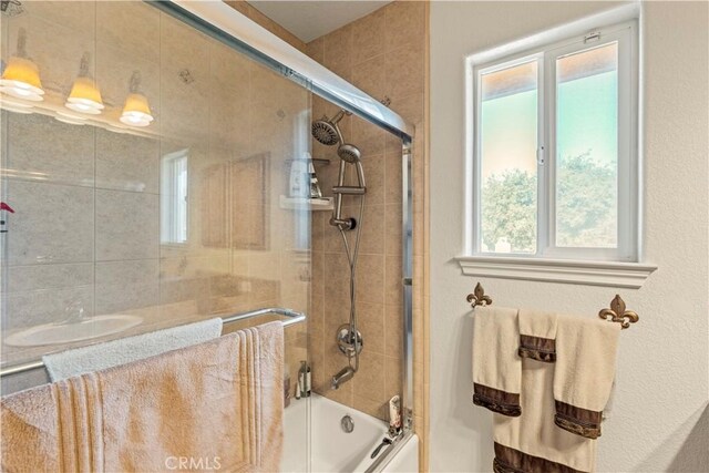 9098 Rattlesnake Rd, Phelan, CA 92371 - bathroom with bath / shower combo with glass door and plenty of natural light