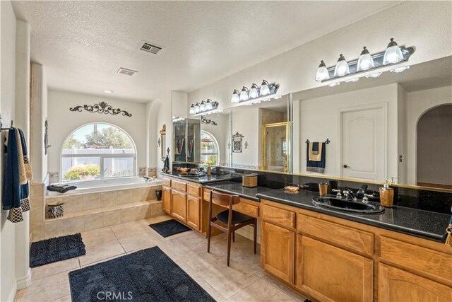 9098 Rattlesnake Rd, Phelan, CA 92371 - full bath with tile patterned floors, a bath, double vanity, a shower stall, and a textured ceiling