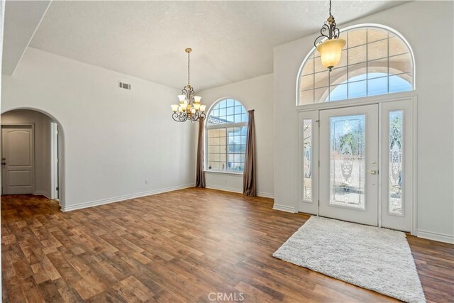 9098 Rattlesnake Rd, Phelan, CA 92371 - foyer entrance with a chandelier, wood finished floors, arched walkways, and a textured ceiling
