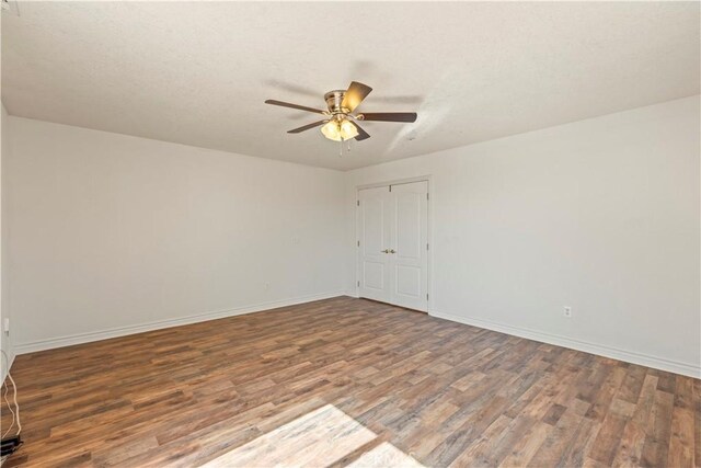 9098 Rattlesnake Rd, Phelan, CA 92371 - empty room with wood finished floors, ceiling fan, and baseboards