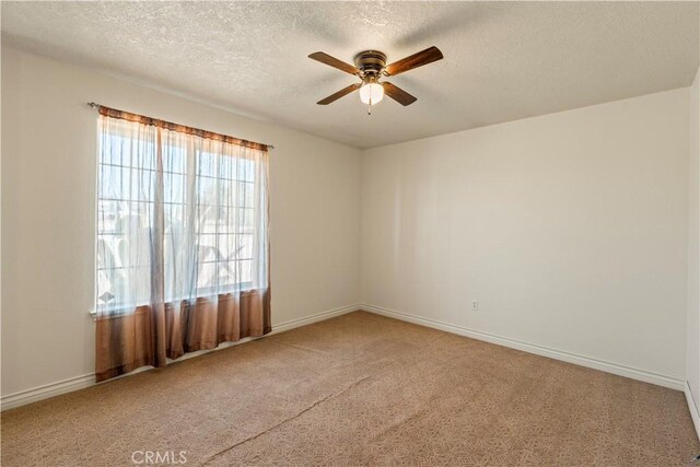 9098 Rattlesnake Rd, Phelan, CA 92371 - spare room with a ceiling fan, carpet, a textured ceiling, and baseboards