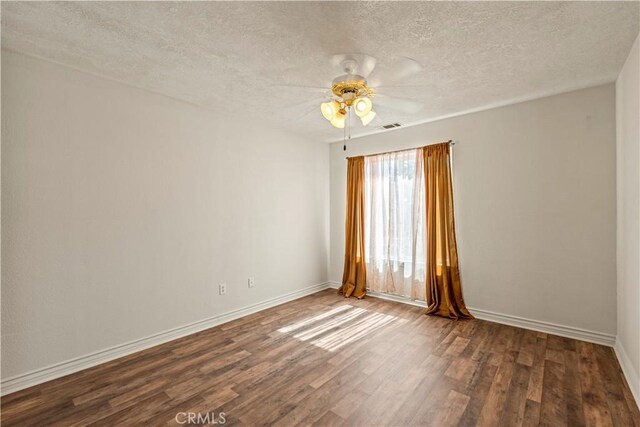 9098 Rattlesnake Rd, Phelan, CA 92371 - spare room with a textured ceiling, wood finished floors, a ceiling fan, and baseboards