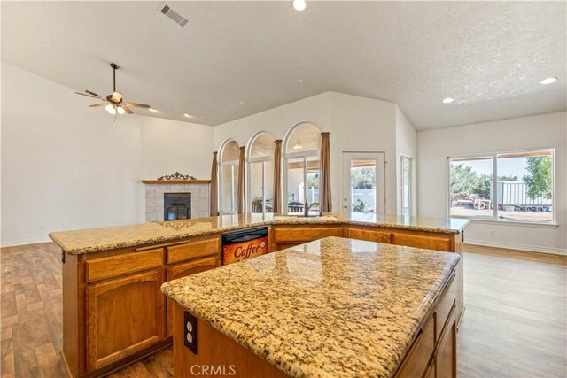 9098 Rattlesnake Rd, Phelan, CA 92371 - kitchen featuring a center island, dishwashing machine, open floor plan, ceiling fan, and wood finished floors