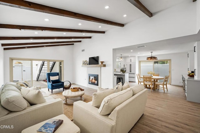 4834 Island View St, Oxnard, CA 93035 - living area featuring recessed lighting, light wood-style floors, a glass covered fireplace, stairway, and beam ceiling