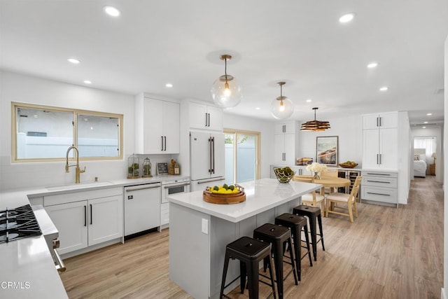 4834 Island View St, Oxnard, CA 93035 - kitchen featuring white appliances, a kitchen breakfast bar, recessed lighting, white cabinetry, and light countertops