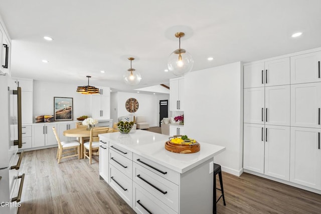4834 Island View St, Oxnard, CA 93035 - kitchen featuring light wood-style flooring, white cabinets, recessed lighting, light countertops, and decorative light fixtures
