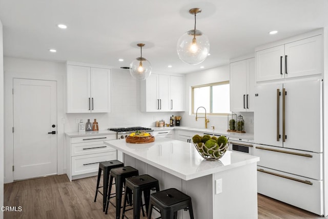 4834 Island View St, Oxnard, CA 93035 - kitchen with high end white refrigerator, a kitchen breakfast bar, a kitchen island, light countertops, and white cabinets