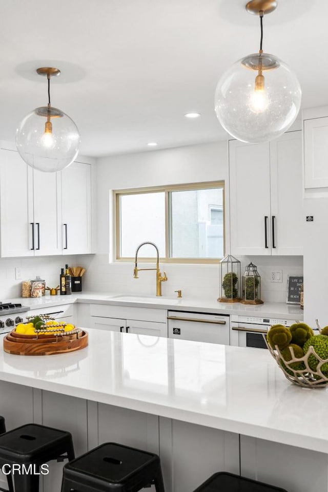 4834 Island View St, Oxnard, CA 93035 - kitchen with white dishwasher, a kitchen bar, light countertops, and recessed lighting