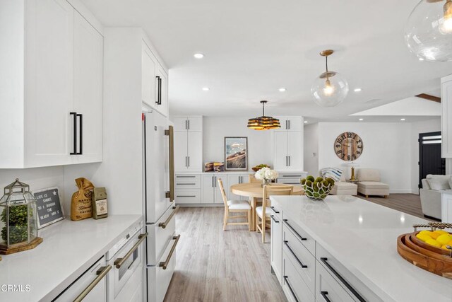 4834 Island View St, Oxnard, CA 93035 - kitchen featuring freestanding refrigerator, white cabinetry, recessed lighting, light countertops, and open floor plan