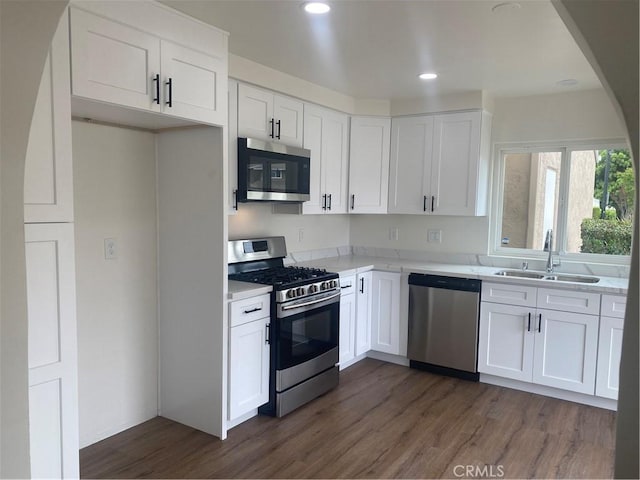 44516 La Paz Rd, Temecula, CA 92592 - kitchen with stainless steel appliances, dark wood-style flooring, white cabinets, recessed lighting, and light stone counters