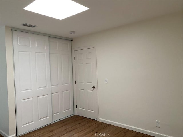 44516 La Paz Rd, Temecula, CA 92592 - unfurnished bedroom featuring wood finished floors and a closet