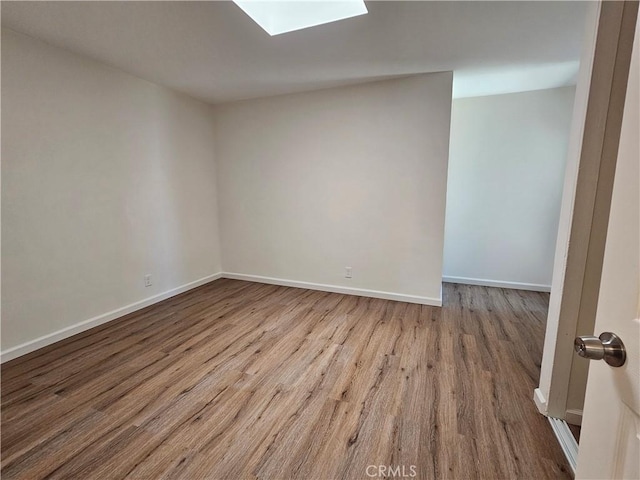 44516 La Paz Rd, Temecula, CA 92592 - unfurnished room featuring wood finished floors and a skylight