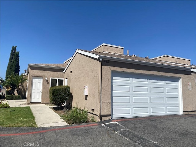 44516 La Paz Rd, Temecula, CA 92592 - view of front of house featuring a garage, stucco siding, and asphalt driveway