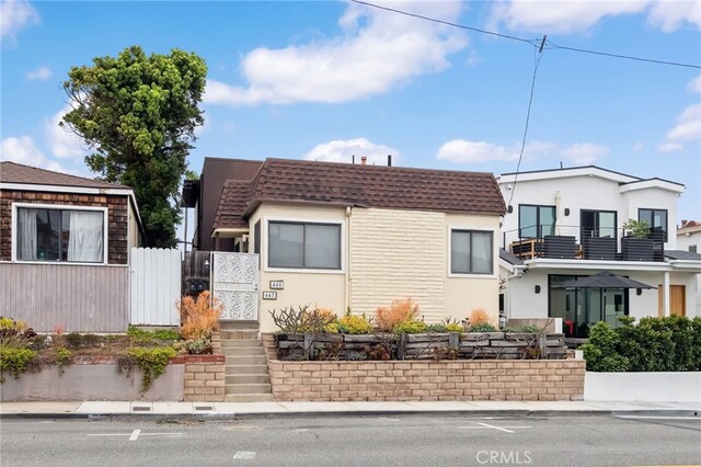 445 Longfellow Ave, Hermosa Beach, CA 90254 - view of front of home with a shingled roof, stucco siding, and mansard roof