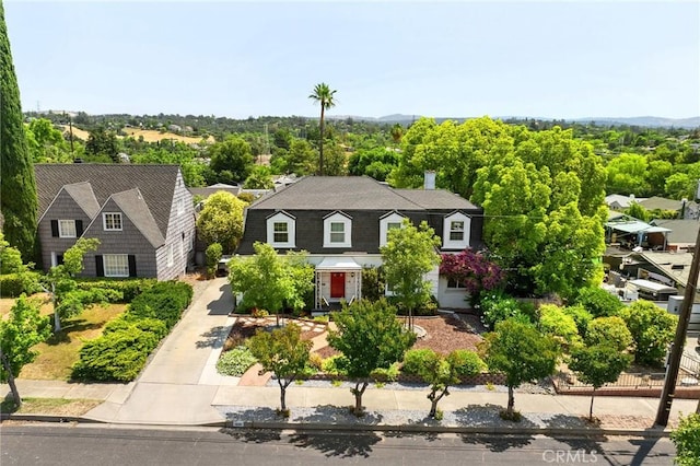1539 Hammon Ave, Oroville, CA 95966 - view of front of home with concrete driveway, a gambrel roof, and a chimney